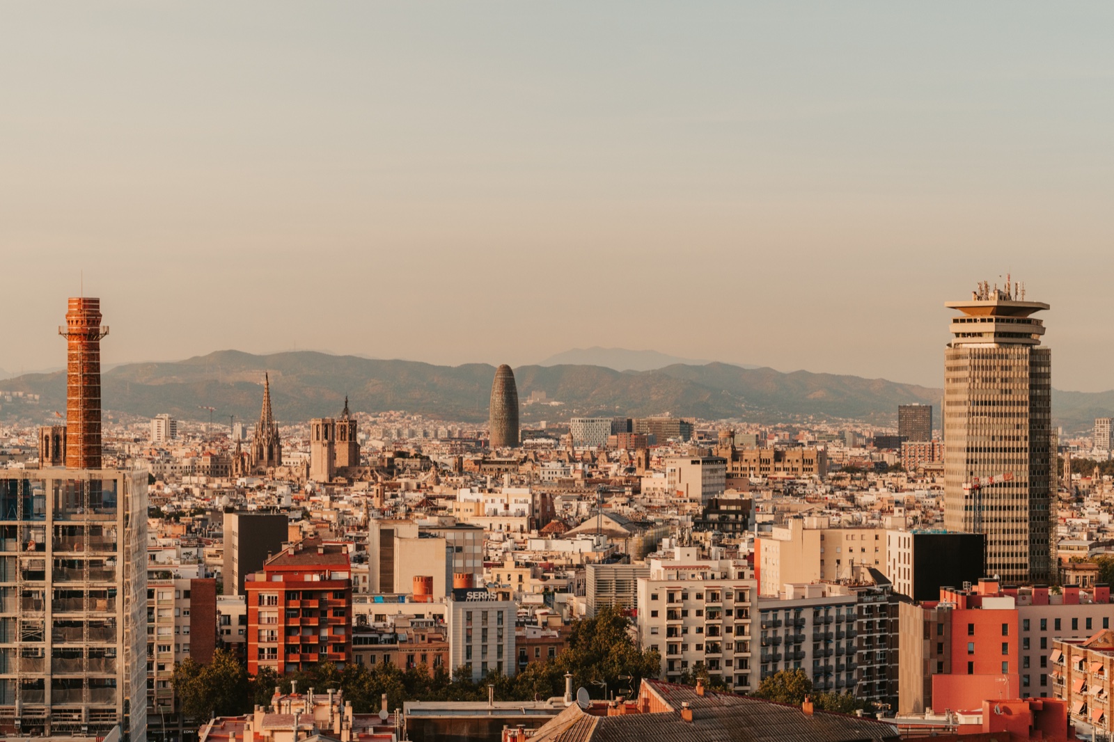 Barcelona’s rooftops stretching to the hills, with Torre Glòries on the skyline